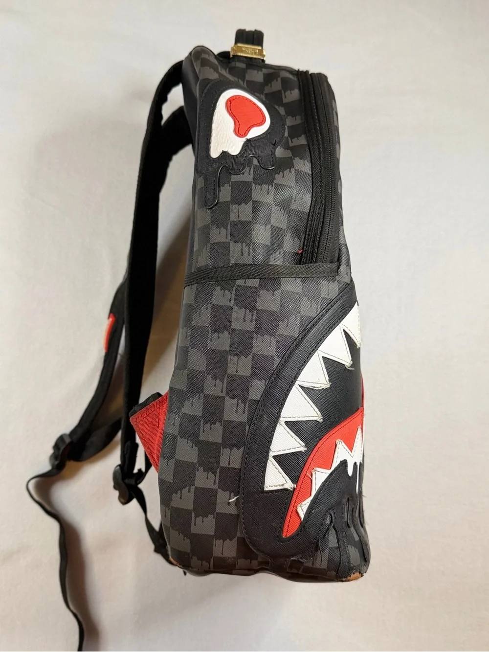 Sprayground Black Checkered Backpack with White and Red Shark Graphic